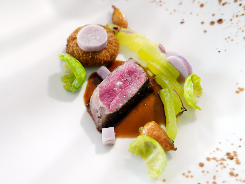 Seared Japanese A5 Wagyu served with honeydew, smoked purple potato, and a black truffle croquette explosion. 