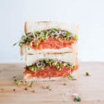 Smoked salmon sandwich with dill cream cheese, capers and fresh alfalfa sprouts on toasted sourdough