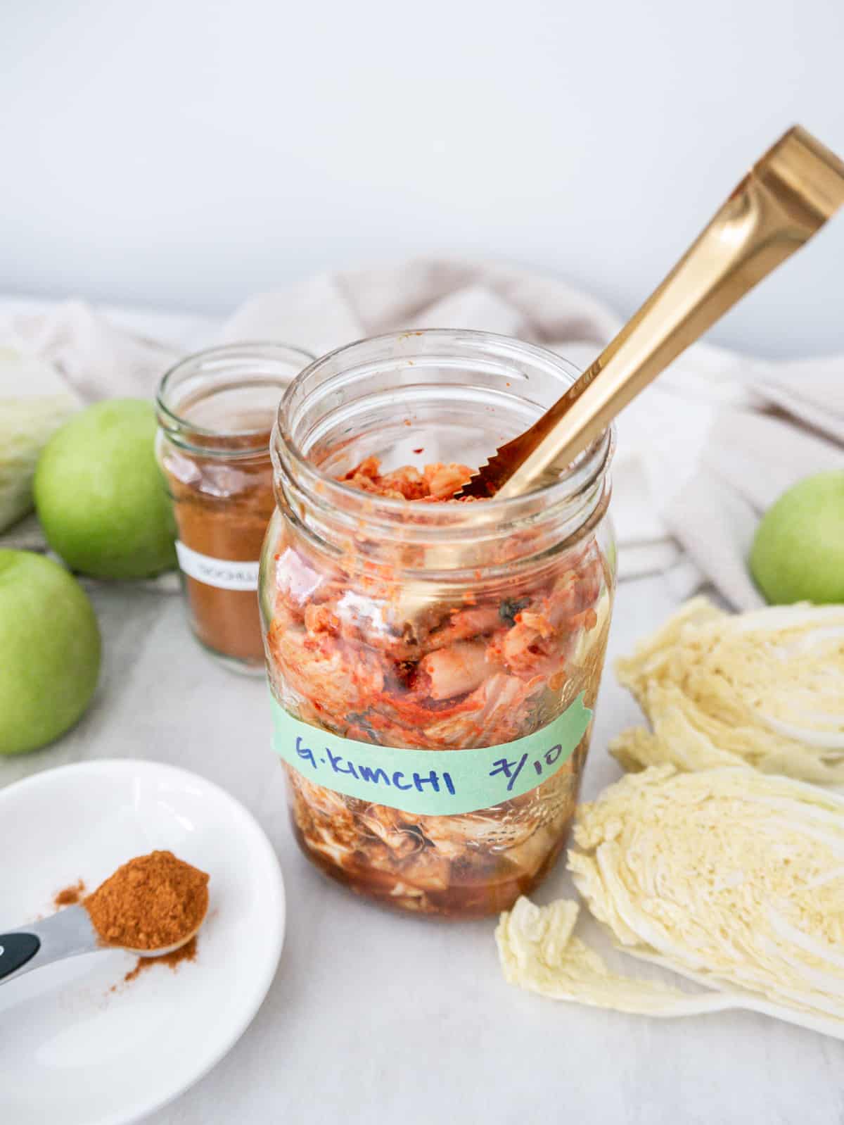Quick Spicy Green Apple Kimchi (Vegan No Fish Sauce) with tongs