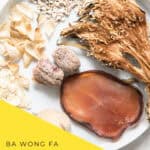 Overhead view of ba wong fa lung moistening soup with dried herbs and ingredients on rustic table