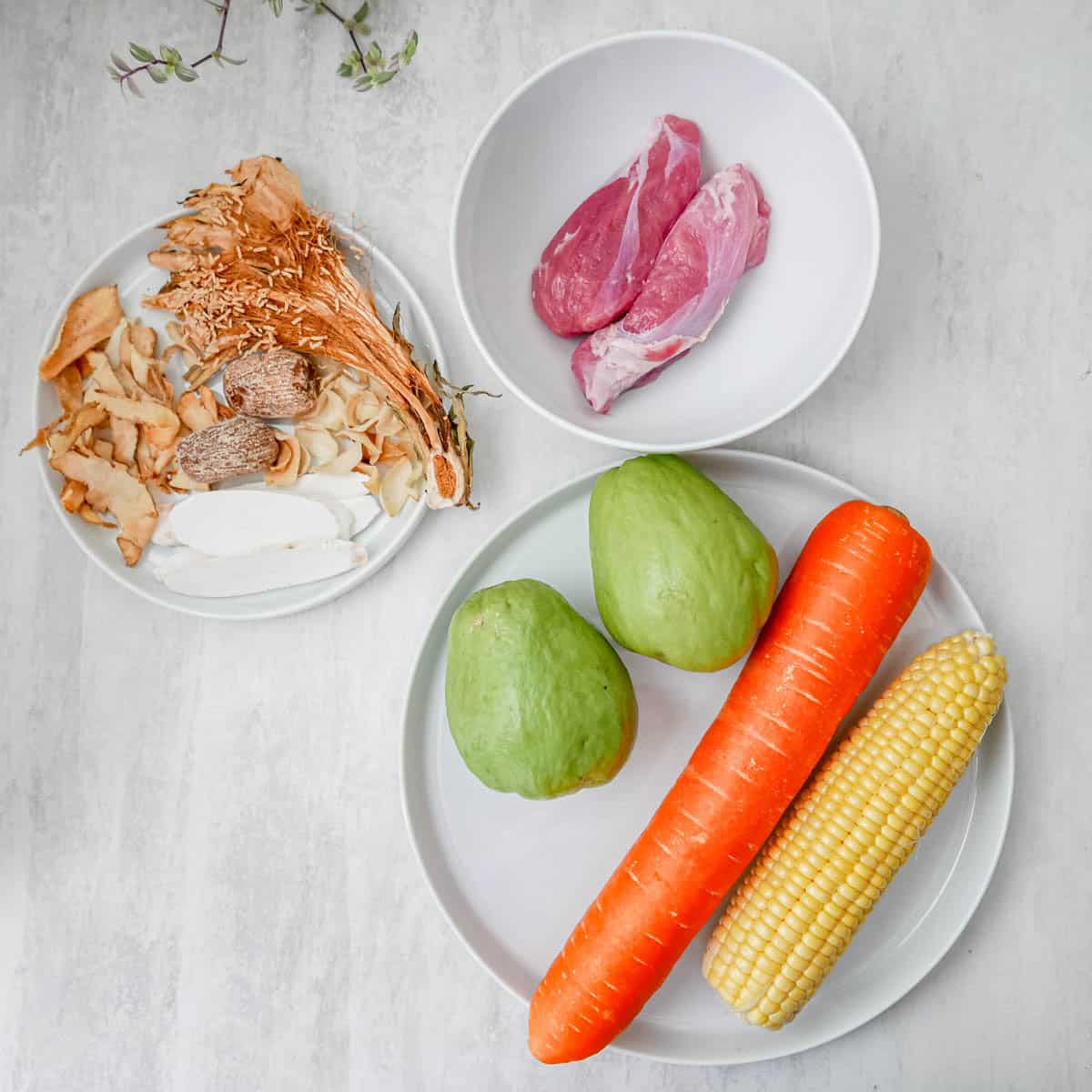 Overhead view of ba wong fa lung moistening soup with dried herbs and ingredients on marble table