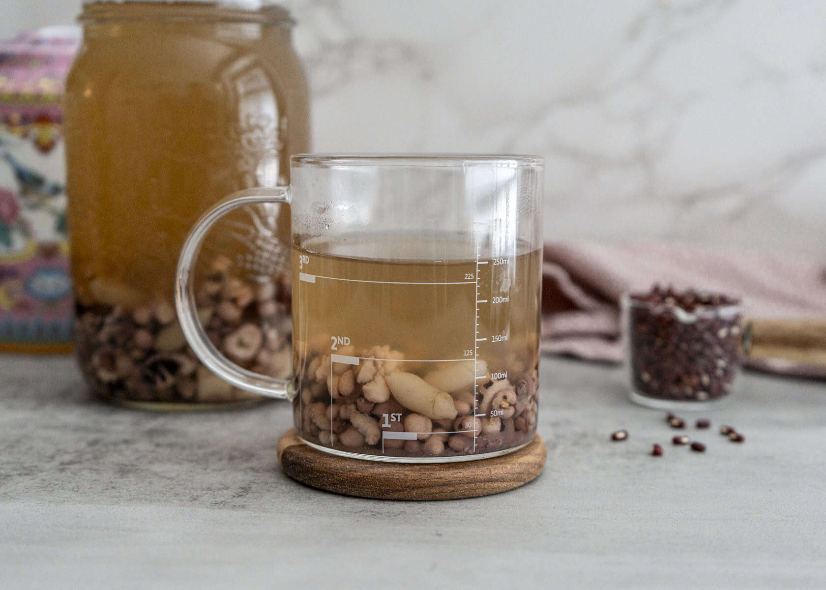 San Fu Period soup ingredients - adzuki beans, Job's tears, Poria mushroom and Mai Dong arranged on wooden table