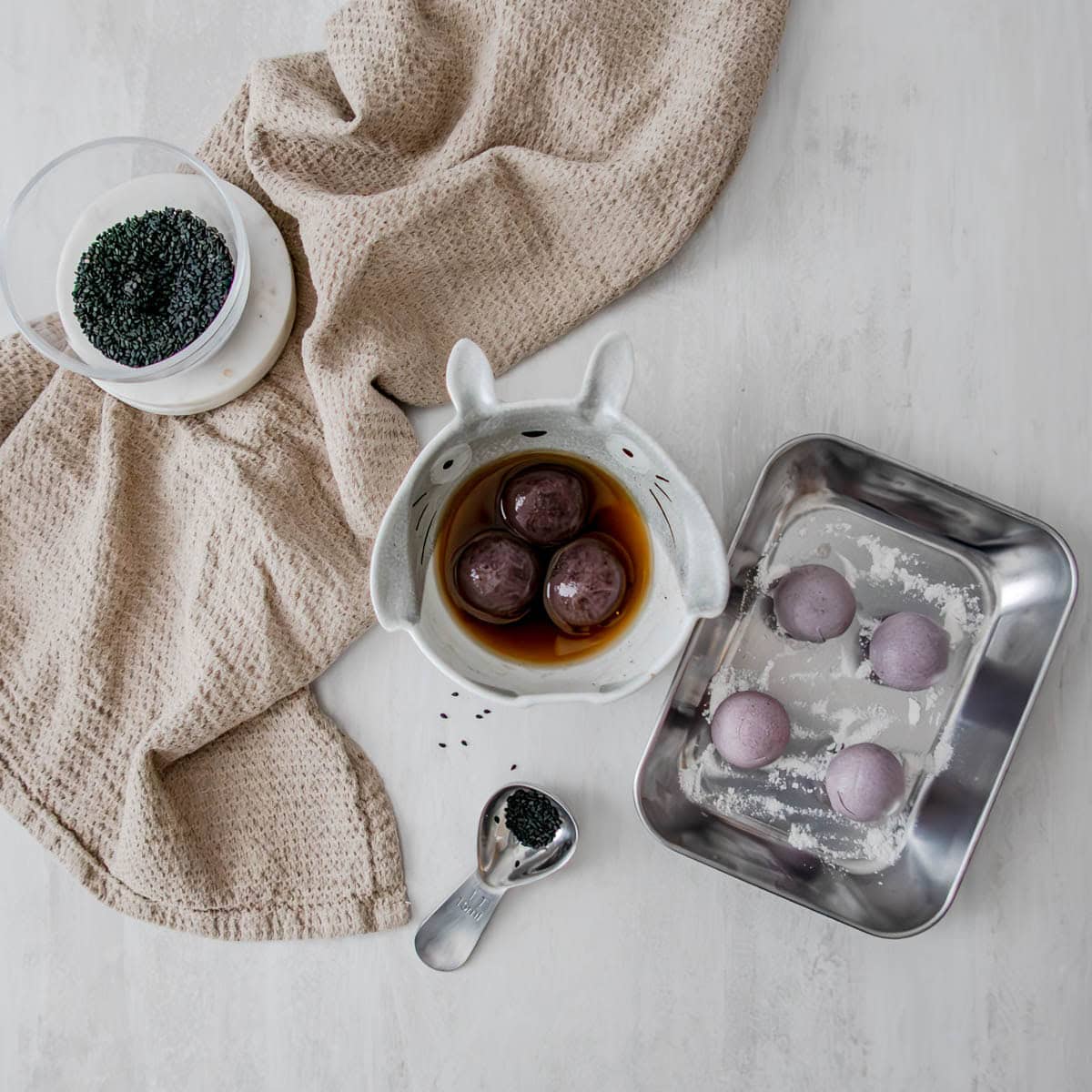 Black sesame tang yuan served in ginger rock sugar broth for authentic Chinese dessert