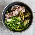 Discover this authentic bitter melon soup recipe with pork ribs and pickled greens. Traditional Chinese medicine cooling soup perfect for summer heat. Ready in 3 hours!