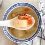 Finished peach gum dessert soup in white AND BLUE bowl showing gelatinous texture