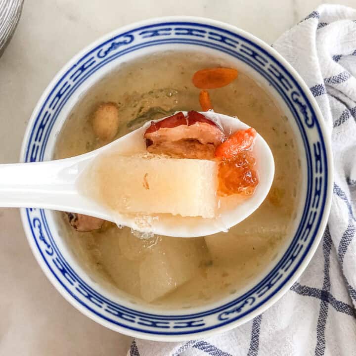 Finished peach gum dessert soup in white AND BLUE bowl showing gelatinous texture