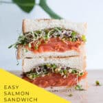 Layering smoked salmon slices on dill cream cheese toast for sandwich assembly