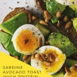 Close up of sardine avocado toast garnished with cilantro and lemon juice