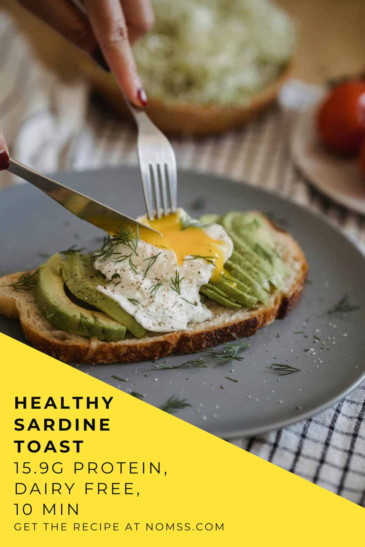 cutting poached egg on top of Close up of sardine avocado toast garnished with cilantro and lemon juice