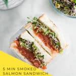 Layering smoked salmon slices on dill cream cheese toast for sandwich assembly