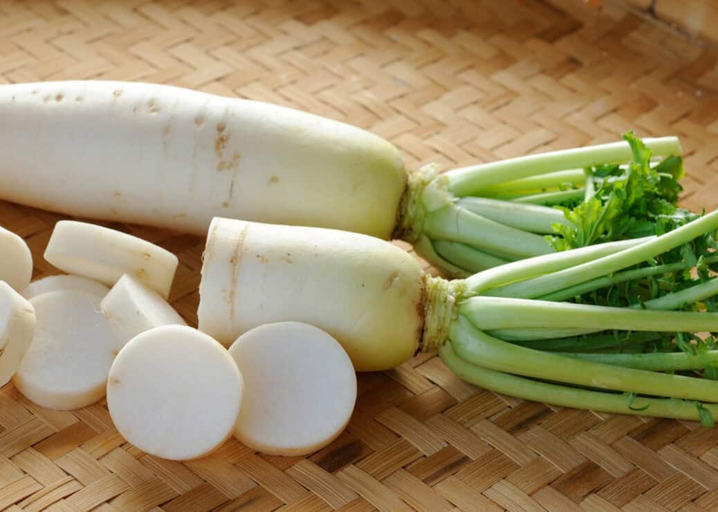 Fresh whole daikon radish 蘿蔔 on wooden board for Cantonese lo bak go recipe
