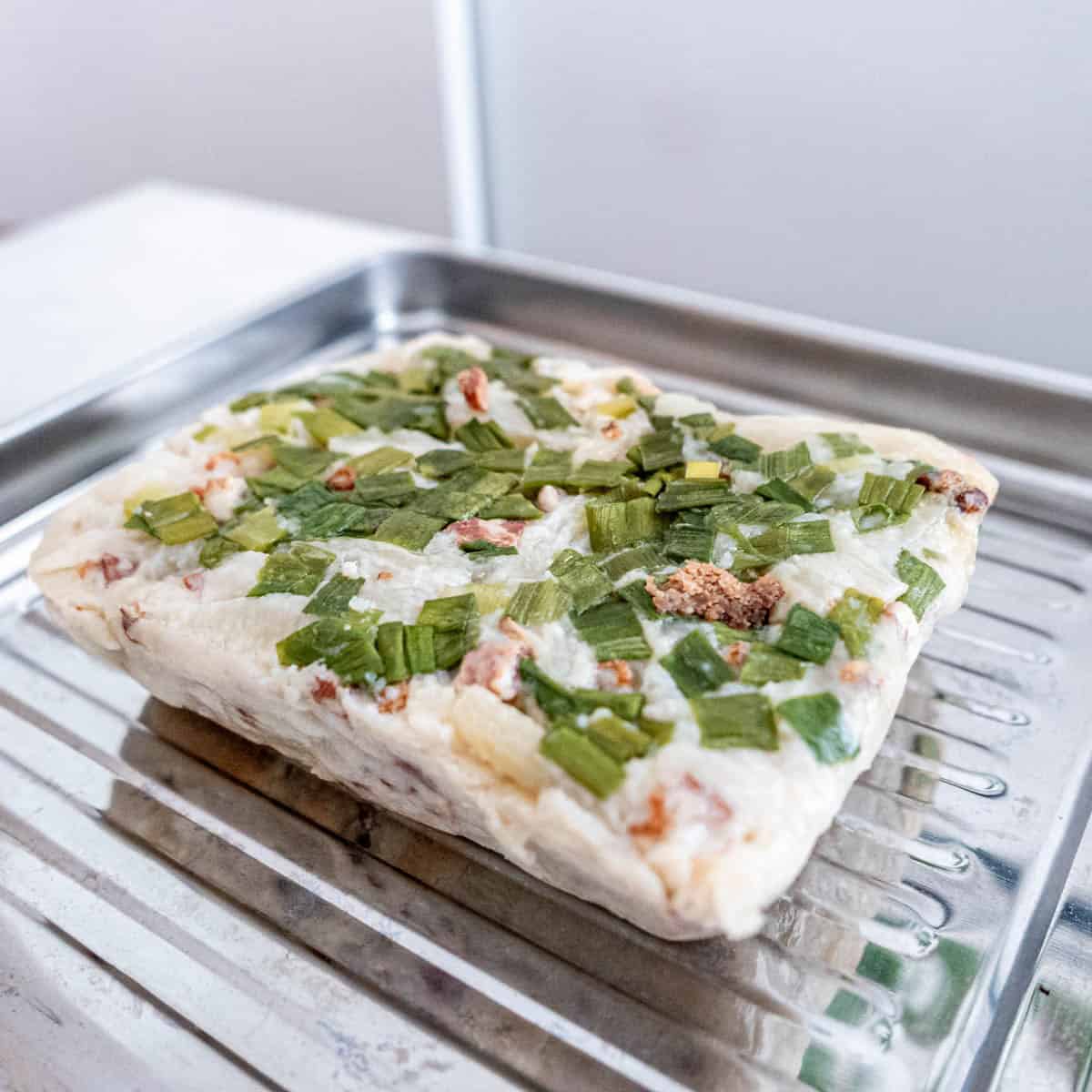 Whole steamed lo bak go Chinese turnip cake fresh from steamer with green onions on top