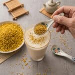 Step 3: Crumbled dried osmanthus 乾桂花碎 sprinkled over osmanthus honey milk and stirred gently with a spoon